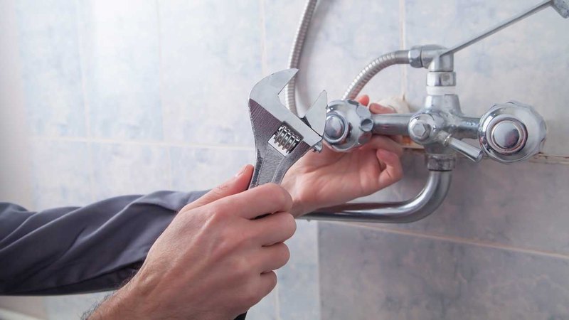 Man using tools for swift and accurate plumber shower repair